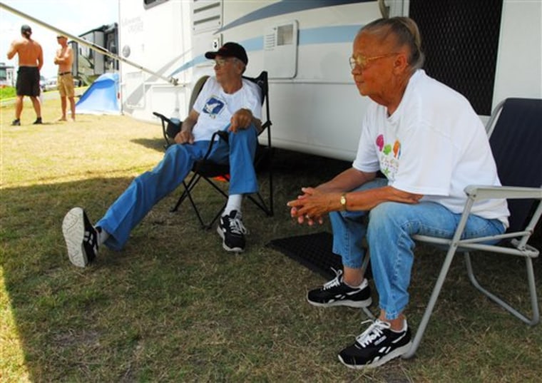 Richard Hutto and and his wife Glenda, who arrived from South Carolina on Monday, sit by their camper along the Indian River just east of the Max Brewer Bridge in Titusvsille, Fla., for front row seats for the shuttle launch. They have been coming to see all the shuttle launches since 1982 with exceptions of health reasons and the birth of grandchildren. k)